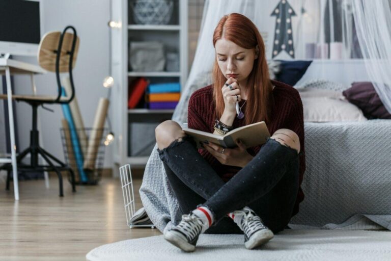 Girl thinking over notebook