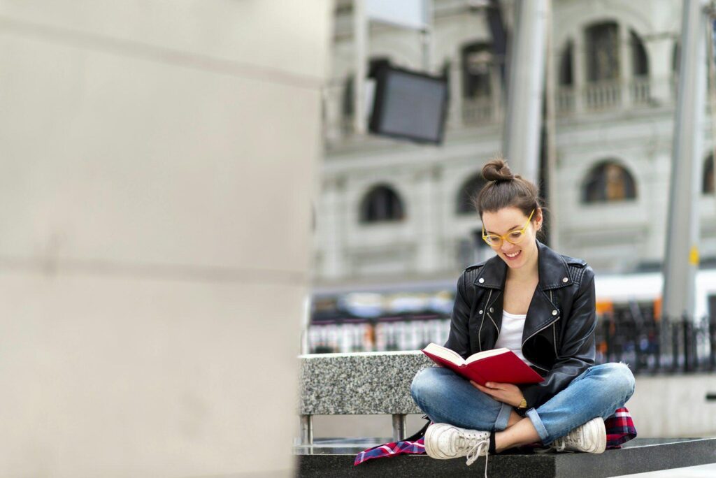 Woman reading book on bench