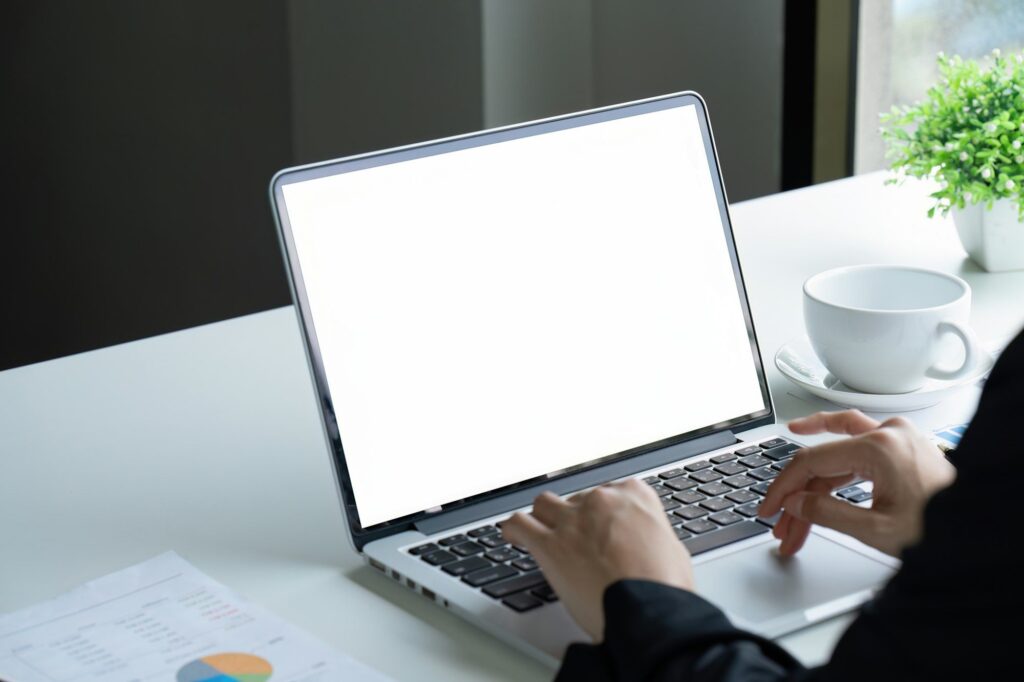 Businesswoman working on laptop with blank screen with copy space screen for your advertising text