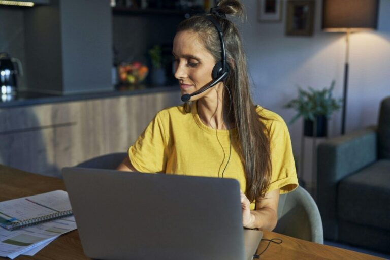 Caucasian woman working as call center at home