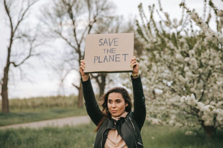 Portrait of cute woman with a banner with the slogan Save the Planet.