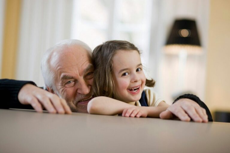 old man and young girl smiling