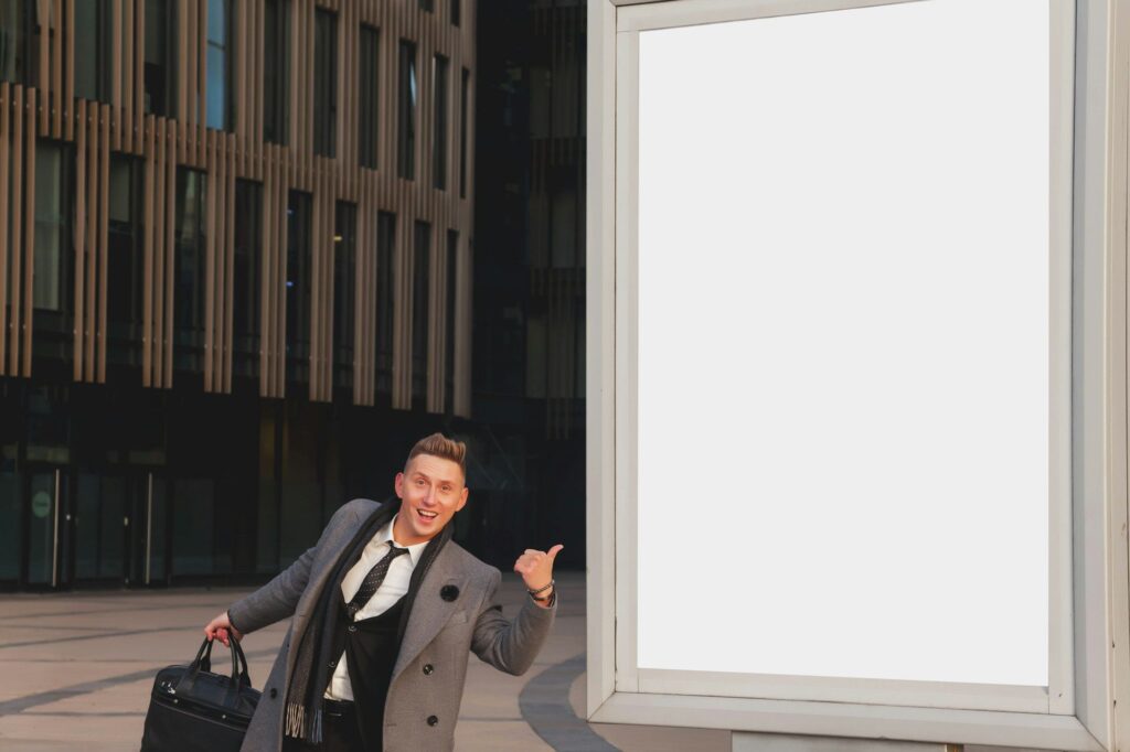 Positive friendly businessman guy for presentation or advertising of product