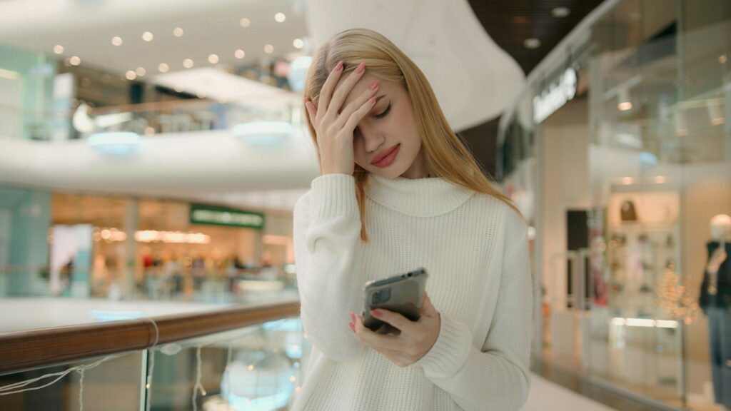 Sad Caucasian puzzled anxious female businesswoman 25s woman has problem with smartphone receive bad