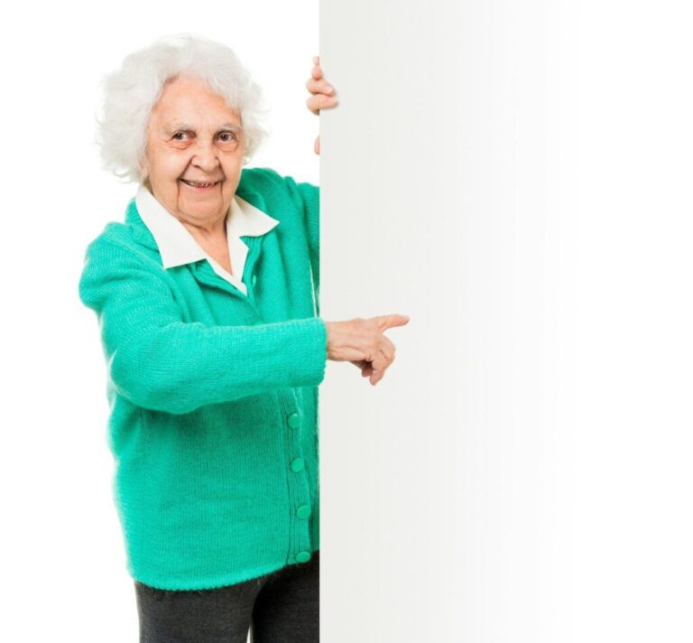 elderly woman alongside of ad board