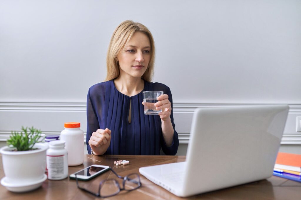 Nutritionology, female nutritionist consulting online,looking at laptop screen talking to patient