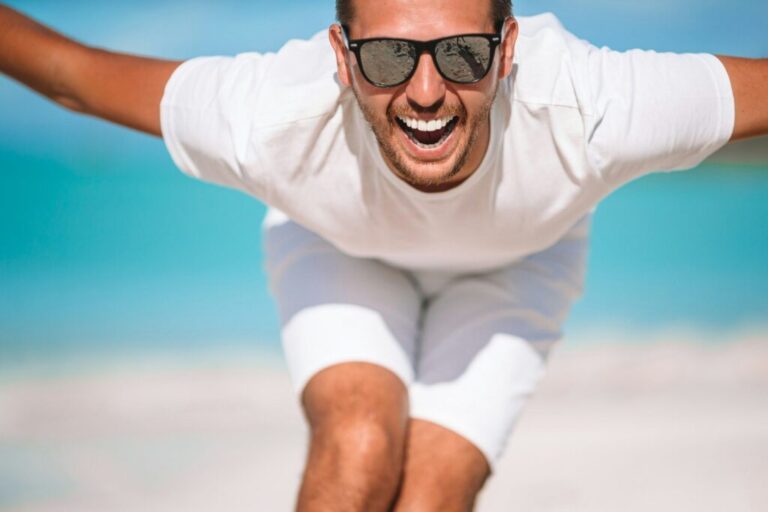 Young man on the beach have fun and fooling