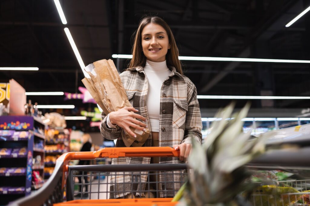 Portrait of satisfied female buyer in grocery store.