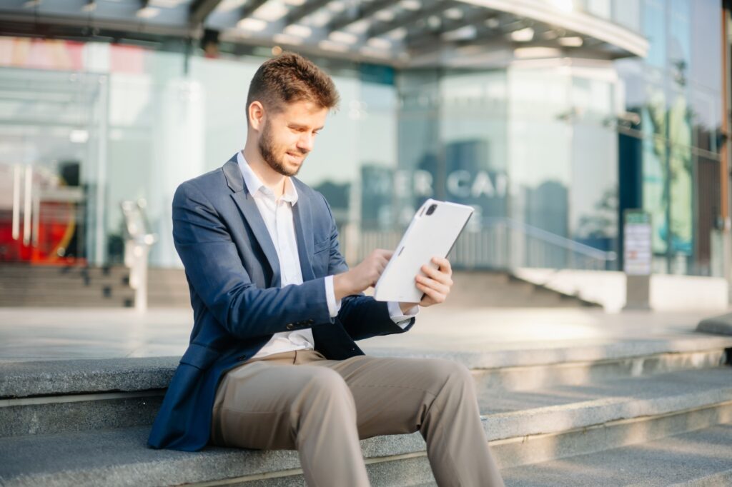 Young business man leader entrepreneur, professional manager holding digital tablet computer