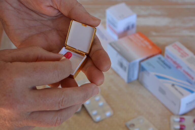 Pharmaceuticals. Woman taking pill out of pill box